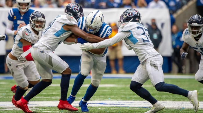 Oct 31, 2021; Indianapolis, Indiana, USA; Indianapolis Colts running back Jonathan Taylor (28) is tackled by multiple Tennessee Titans during the second half at Lucas Oil Stadium. Titans won 34-31.